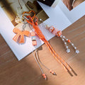 Orange bow bag charm